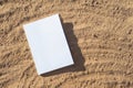 blank book mockup on sandy beach