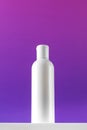 Blank bottle of mincellar water on purple background. Cleanness and refreshing procedures