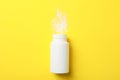 Blank bottle of talcum powder on yellow background space for text Royalty Free Stock Photo