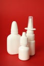 Blank bottles of nasal spray on red background Royalty Free Stock Photo