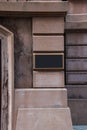 Blank brass plaque on stone building wall.