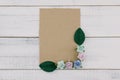 Blank brown card decorate with blue tone paper flowers and green leaves Royalty Free Stock Photo