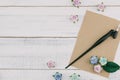 Blank brown card and oblique pen decorate with blue tone paper flowers Royalty Free Stock Photo