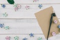 Blank brown card and oblique pen decorate with blue tone paper flowers Royalty Free Stock Photo