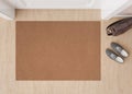 Blank brown door mat on the floor at home. Welcome mat with copy space for your text. Doormat mock up. Carpet at