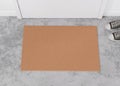 Blank brown door mat on the floor at home. Welcome mat with copy space for your text. Doormat mock up. Carpet at Royalty Free Stock Photo