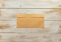 Blank brown envelope on white washed wooden background Royalty Free Stock Photo