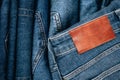 Blank brown leather label sewed on a blue denim jeans. Mock up navy jeans tag. Top view Royalty Free Stock Photo