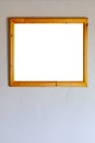 Brown photo frame on a smooth gray wall Royalty Free Stock Photo