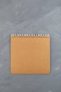 Blank, brown spiral notebook cardboard sheet on grey background. Retro, old vintage beige paper Royalty Free Stock Photo