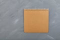 Blank  brown spiral notebook cardboard sheet on grey background. Retro  old vintage beige paper. Design element  copy space Royalty Free Stock Photo