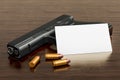 Blank business card for gun shop or firearm store on the wooden desk background. 3D rendering