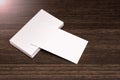 Blank business cards isolated on a dark wooden background