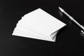 Blank business cards with pen on dark background Royalty Free Stock Photo