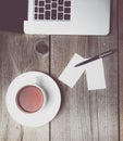 Blank business cards with pen, laptop and tea cup on wooden office table Royalty Free Stock Photo