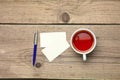 Blank business cards with pen and tea cup on wooden office table Royalty Free Stock Photo