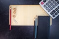 Blank business office empty wood sign with no writing pencils checkbook and calculator flat lay background