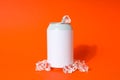 Blank can with ice cubes on orange background Royalty Free Stock Photo