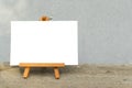 Blank canvas on an easel. Empty place. Mock up, template. White sheet of paper on a stand