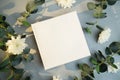 Blank canvas frame, white flowers and plant branches. Royalty Free Stock Photo