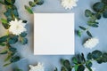 Blank canvas frame, white flowers and plant branches. Royalty Free Stock Photo