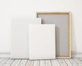 Blank canvas or poster with pile of canvas on floor and wall, background