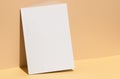 A blank canvas stands on a beige background, with copy space Royalty Free Stock Photo