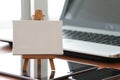 Blank canvas and wooden easel on laptop computer