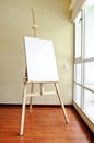 Blank canvas on a wooden tripod in the studio