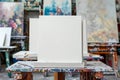 Blank Canvases Ready for Painting on Easels in an Artistic Studio with Colorful Paintings in Background