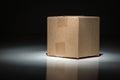 Blank Carboard Shipping Box Under Spot Light. Royalty Free Stock Photo