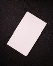 Blank card on dark texture background. White contact card for your design