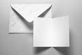 Blank card and envelope over grey background Royalty Free Stock Photo