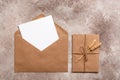 Blank card mockup in a craft envelope. Vintage letter tied with twine with ears of ripe wheat. Invitation template. Beige grunge Royalty Free Stock Photo