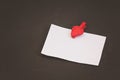 Blank card with space for records on clothespin in the form of strawberries on black stone background Royalty Free Stock Photo