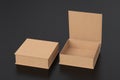 Blank cardboard flat square gift box with open and closed hinged flap lid on black background.