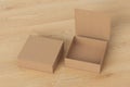 Blank cardboard flat square gift box with open and closed hinged flap lid on wooden background.