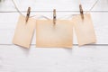 Blank cards on rope on light wall background Royalty Free Stock Photo