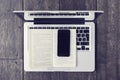 Blank cell phone with open book and laptop Royalty Free Stock Photo