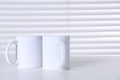 Blank ceramic mugs on white table. Mockup for design Royalty Free Stock Photo