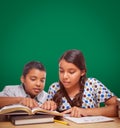 Blank Chalk Board Behind Hispanic Boy and Girl Having Fun Studying Royalty Free Stock Photo