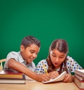 Blank Chalk Board Behind Hispanic Boy and Girl Having Fun Studying Royalty Free Stock Photo