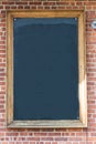 Blank chalkboard on brick wall Royalty Free Stock Photo