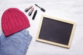 Blank chalkboard with copyspce and women's essentials on white w