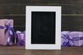 blank chalkboard in frame with gift boxes