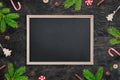 Blank chalkboard for greeting text surrounded by Christmas decorations Royalty Free Stock Photo