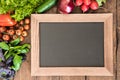 Blank chalkboard with group of fresh vegetables for cooking breakfast. Enjoy your meal concept Royalty Free Stock Photo