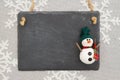 Blank chalkboard sign with a snowman on snowflakes Royalty Free Stock Photo