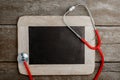 Blank chalkboard, stethoscope, health background concepts. Royalty Free Stock Photo