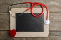 Blank chalkboard, stethoscope and red heart, health background c Royalty Free Stock Photo